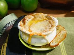 a bowl filled with food sitting on top of a green plate