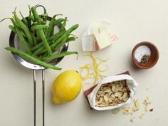 some food is sitting on a table with lemons, nuts and other things to eat