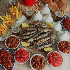 a table topped with lots of food and condiments on top of each other