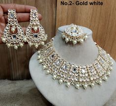 *Light Weight Kundan layered necklace set with earrings and tikka. *Studded with kundan stone. *Light Weight Gold kundan necklace. *No.1-  * Necklace width- 1.4 inches( Included drops) *Earrings Length- 2.6 inches(included pearl drop) *Earrings width Size- 1.4 inches *No.2-  * Necklace width- 1.1 inches( Included drops) *Earrings Length- 3.4 inches(included pearl drop) *Earrings width Size- 1.6 inches White Bollywood Kundan Necklace For Celebration, White Kundan Necklace With Stone Work For Party, White Kundan Necklace For Celebrations, White Chandbali Kundan Necklace For Diwali, White Bollywood Kundan Necklace For Festive Occasions, White Kundan Tikka For Diwali, Bollywood Style White Kundan Bridal Necklace, White Bridal Necklace For Diwali, Heavy White Kundan Necklace For Festivals