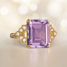 An Stunning 18k Yellow Gold Ring Centering An Emerald Cut Amethyst Luxury Amethyst Ring Emerald Cut, Luxury Emerald Cut Amethyst Ring, Luxury Purple Amethyst Ring, Rectangular Shape, Elegant Purple Amethyst Baguette Cut Ring, Elegant Purple Baguette Cut Amethyst Ring, Luxury Purple Amethyst Rectangular Ring, Luxury Purple Rectangular Amethyst Ring, Luxury Emerald-cut Amethyst Ring For Formal Events, Luxury Emerald Cut Amethyst Ring For Formal Occasions