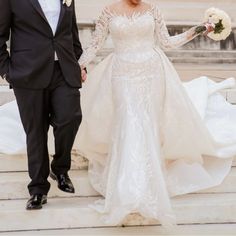 the bride and groom are walking down the steps