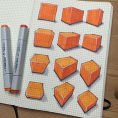 an open notebook with drawings of cubes and pencils on the paper next to it