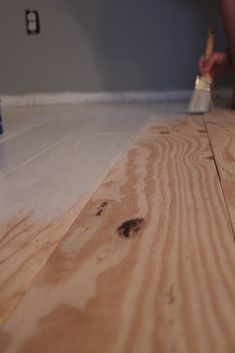 someone using a brush to paint the floor