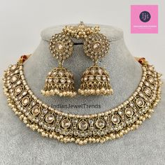 White Antique Polki Kundan necklace set/Reverse Ad Necklace/Statement necklace/Indian/Punjabi Necklace/Pakistani Jewelry/Bridal necklace/ Antique Reverse Ad Stone Necklace With Mehndi Plating Regular Size And Adjustable Stone Necklace Antique Necklace Set with dull gold finish  This is 100% Handmade jewelry. So Color, shades, texture displayed may slightly vary from the actual product due to digital image limitations. We request you to consider these minor variations. Please expect the possibility of some slight imperfections when buying hand made jewelry. If you have any questions, please message or email us. Arrives in gift box. Please let me know if you have any questions. Thank you so much visiting my shop. Heavy Temple Jewelry Necklaces For Eid, Heavy Temple Jewelry Bridal Necklace For Eid, Heavy Round Bollywood Necklaces, Heavy Round Bollywood Style Necklace, Heavy Necklace For Eid Celebration, Heavy Necklaces For Eid Celebration, Heavy Chandbali Necklaces For Eid, Bollywood Jewelry Sets For Ceremonial Eid, Bollywood Style Ceremonial Jewelry Set For Eid