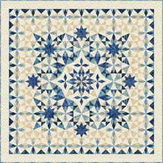 a blue and white quilt with an intricate design on the front, in shades of beige