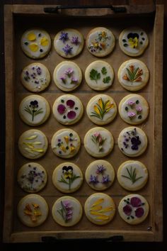 a box filled with lots of decorated cookies