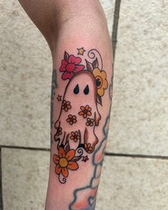 a person with a tattoo on their arm has a flowered ghost in the background