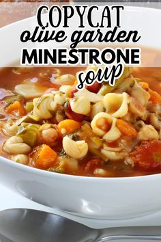 a white bowl filled with pasta and vegetable soup