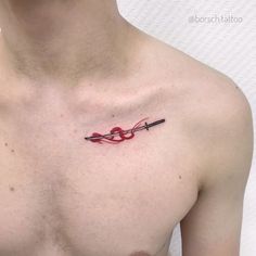 a man's chest with a red thread tattoo on the left side of his chest