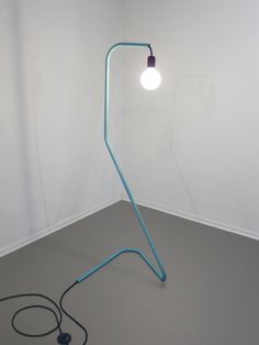 a floor lamp with a cord attached to it and a light bulb on the end