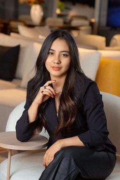 a woman sitting on top of a white couch