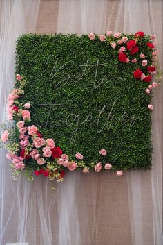 a green wall with flowers and the words happy together