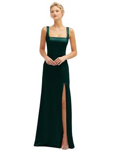 a woman in a long green dress with a slit down the side and her hand on her hip