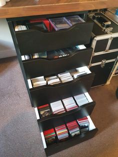 a book shelf filled with lots of books on top of a carpeted floor