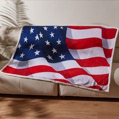 an american flag is draped on the back of a couch