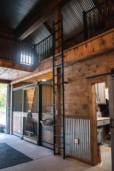 the inside of a wooden building with metal railings