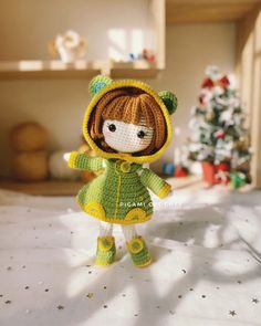 a small doll is dressed in green and yellow