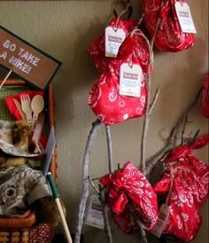 red hearts are hanging on the wall next to other decorations and items that include spoons