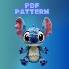 a crocheted stitched blue and white stuffed animal with big ears sitting in front of a blue background