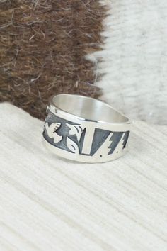 This sterling silver ring was made by Hopi silversmith Timothy Mowa. The inside is stamped sterling.Size: 12Length: 1"Free shipping on all orders! We ship with USPS and always include tracking. All orders ship within a day of payment.Returns are accepted up to 30 days after you receive your order. Just send us a message. Our shop offers cash back or store credit. The item must be returned in new condition. Stamped Sterling Silver Wide Band Jewelry, Sterling Silver Engraved Wide Band Ring, Unique Engraved Wide Band Ring In Sterling Silver, Symbolic Sterling Silver Stamped Rings, Symbolic Stamped Sterling Silver Rings, Sterling Silver Stamped Rings For Collectors, Collectible Sterling Silver Ring With Wide Band, Native American Jewelry, Free Jewelry