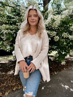 Model is 5'1" 34D, 6/28 and is wearing a size small. Item runs oversized. Our Almond Cream Sweater features a super soft creamy almond hued knit material, v-neckline, long ribbed sleeves with side slits on cuffs, reverse hi-lo hemline with small slits on sides. More details: 49% viscose 28% poly 24% nylon. hand wash or wash on cold and hang to dry. Cream Knit Sweater, Almond Cream, Cream Sweater, Short Leggings, Knitting Materials, Skirt Pants, Denim Pants, Set Dress, Knit Sweater