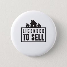 a button with the words license to sell printed on it, in black and white