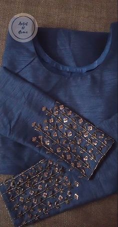 a blue shirt with gold sequins on it