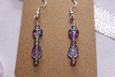 These cute handmade earrings are great for any occasion! With translucent purple heart and leaf beads, these earrings make awesome gifts, whether it is for someone else, or yourself! They are lightweight, comfortable to wear, and handmade with love! Plus, they have free shipping! What could be better? Thank you for checking out my shop! Hypoallergenic Purple Beaded Earrings, Handmade Purple Dangle Heart Earrings, Handmade Purple Heart Dangle Earrings, Handmade Purple Heart Earrings For Gift, Handmade Purple Heart Earrings Gift, Purple Heart Beads Earrings For Gift, Purple Crystal Earrings With Round Beads, Handmade Lavender Beaded Earrings For Gift, Purple Crystal Earrings With Round Beads For Gift