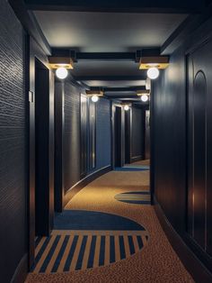 an empty hallway with several lights on either side