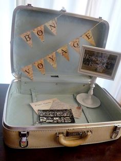 an open suitcase sitting on top of a wooden table next to a sign that says boyce