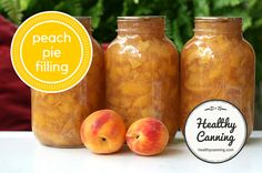 three jars filled with peach pie filling sitting on top of a table next to each other