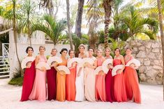 a group of women standing next to each other in dresses and holding fan's