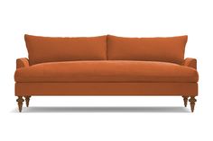 an orange couch sitting on top of a white floor