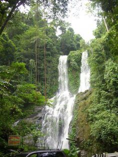 a car parked in front of a waterfall