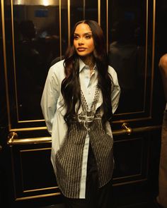 a woman standing in front of an elevator