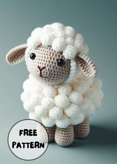 a small crocheted sheep sitting on top of a gray surface with the words free pattern below it