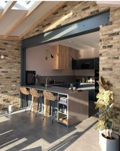 an open kitchen and dining area with skylights