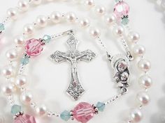 "- Personalized handmade Swarovski crystal pearl rosary in white, pink and green. - Choice of medals and letters - Comes with a pouch and gift box This handmade baptism rosary is made with Swarovski pearls and crystals, and comes personalized with a name. The big pink crystals are offset by green crystals - it reminds me of a rose. Comes with your choice of Baptism, First Communion, Confirmation, or other medals. Read below for details. Over 80 colorful designs to choose from. Enter my shop here Handmade Pink Rosary For First Communion, Handmade Pink Rosary For Baptism, Handmade Pink Jewelry For Baptism, Personalized Rosary, Rosary Gift, Pearl Rosary, First Communion Gifts, Personalized Baby Girl, Communion Gifts