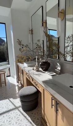 a large bathroom with double sinks and mirrors