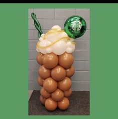 a balloon sculpture made to look like a cupcake with whipped cream and coffee beans