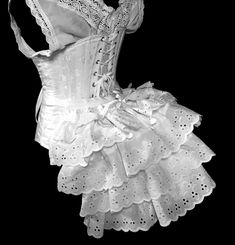 "Too cute to be covered, our ruffled Rustle Bustle makes for a great addition to any costume. Wear on the outside for a cute ruffle-y flare or under your skirt for a traditional Victorian bustled back. Ready to ship in layers of white eyelet lace. Our \"Rustle\" or ruffle bustle is a modest sized bustle with light steel boning, and three fluffy ruffles adding to the fullness. They work well as outerwear or underwear. This listing includes one Rustle, to be worn at the back as a bustle. Your Rust Fantasy Corset Dress With Ruffles For Costume, Fantasy Ruffled Corset Dress For Costume, Fitted Cosplay Costume With Attached Cancan, Fantasy Ruffle Corset Dress For Cosplay, Steampunk Ruffled Corset For Cosplay, Steampunk Ruffles Corset For Cosplay, Cosplay Corset With Attached Cancan, Ruffled Overbust Corset For Costume, Fitted Ruffled Costumes For Cosplay