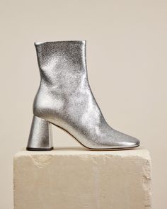 Ankle boot Made by hand in Italy In Harlow, silver becomes a lust-worthy neutral that will readily rotate with your favourite wardrobe staples. We’re styling to bring an ethereal touch to dark suiting. Description A sleek boot shaped by softened lines, including a rounded toe inspired by that of our classic Harlow Pump. Finished in silver crake lamé with flared block heel, internal zipper and buffed outsole. Details Heel height: 7.5cm (3 inches) 100% Italian leather upper. Hand stitched. Leather insole, lining, sock and outsole. Zip closure. Leather block heel. Made by hand in Italy Size & Fit Italian sizingFits true to size, tight ankle fit, select your normal size If between sizes, select the size up for this style Shipping | We ship quickly and offer free exchanges and returns on all or Dear Frances, Flat Mules, Vegan Gifts, Loafer Mules, Leather Block Heels, Boot Shop, Hand Stitched, Italian Leather, Wardrobe Staples