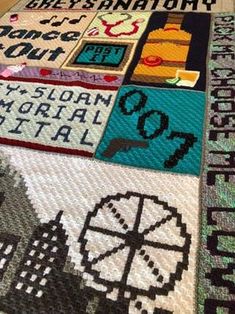 a close up of a rug with many different designs on it, including letters and numbers