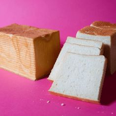 two slices of bread sitting next to each other on a pink surface