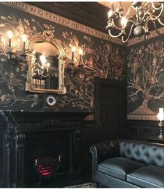 a living room filled with furniture and a fire place under a chandelier hanging from the ceiling