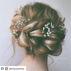 the back of a woman's head with flowers in her hair