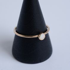 This dainty stacking ring is handmade in solid 14 karat gold. It features a tiny 4mm opal that has been bezel set. This ring is perfect to wear alone or stack with others. Please note that each opal is different and will not be exactly as shown. Want a customized gemstone option? Just reach out Handmade by Metrix Jewelry in New York. All products are made to order, please allow up to 2 weeks before shipping for 14 karat gold items. Contact Hello@MetrixJewelry.com if you require expedited service Opal Stacking Ring, Gemstone Stacking Ring, Gold Items, Opal Ring Gold, Stacking Ring, Opal Gemstone, Opal Rings, Earring Backs, Stacking Rings