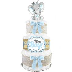 a diaper cake with an elephant on top and blue ribbon around the edges,