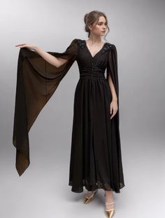 specification Gothic V-neck Dresses For Spring, Black Maxi Evening Dress For Fall, Black Cocktail Evening Dress With Cape Sleeves, Black Cape Sleeve Dresses For Spring, Black Dresses With Cape Sleeves For Spring, Elegant Black Maxi Dress With Cape Sleeves, Black Evening Dress For Fall, Black Floor-length Dinner Midi Dress, Gothic Evening Maxi Dress For Spring